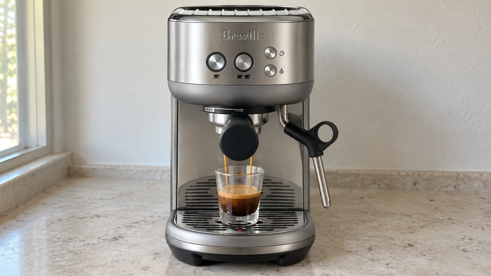Beginner-friendly espresso machine pulling a shot into a glass