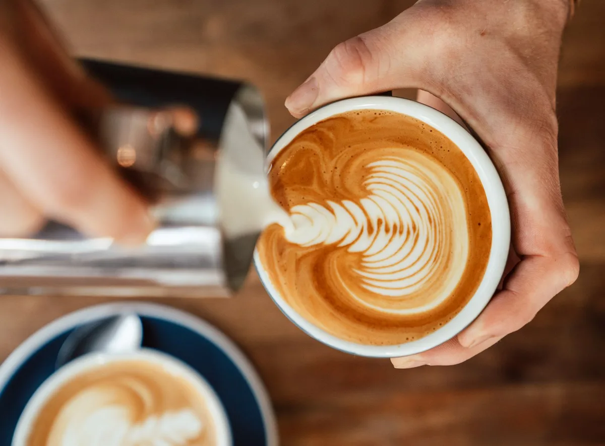 Barista preparing coffee behind the bar