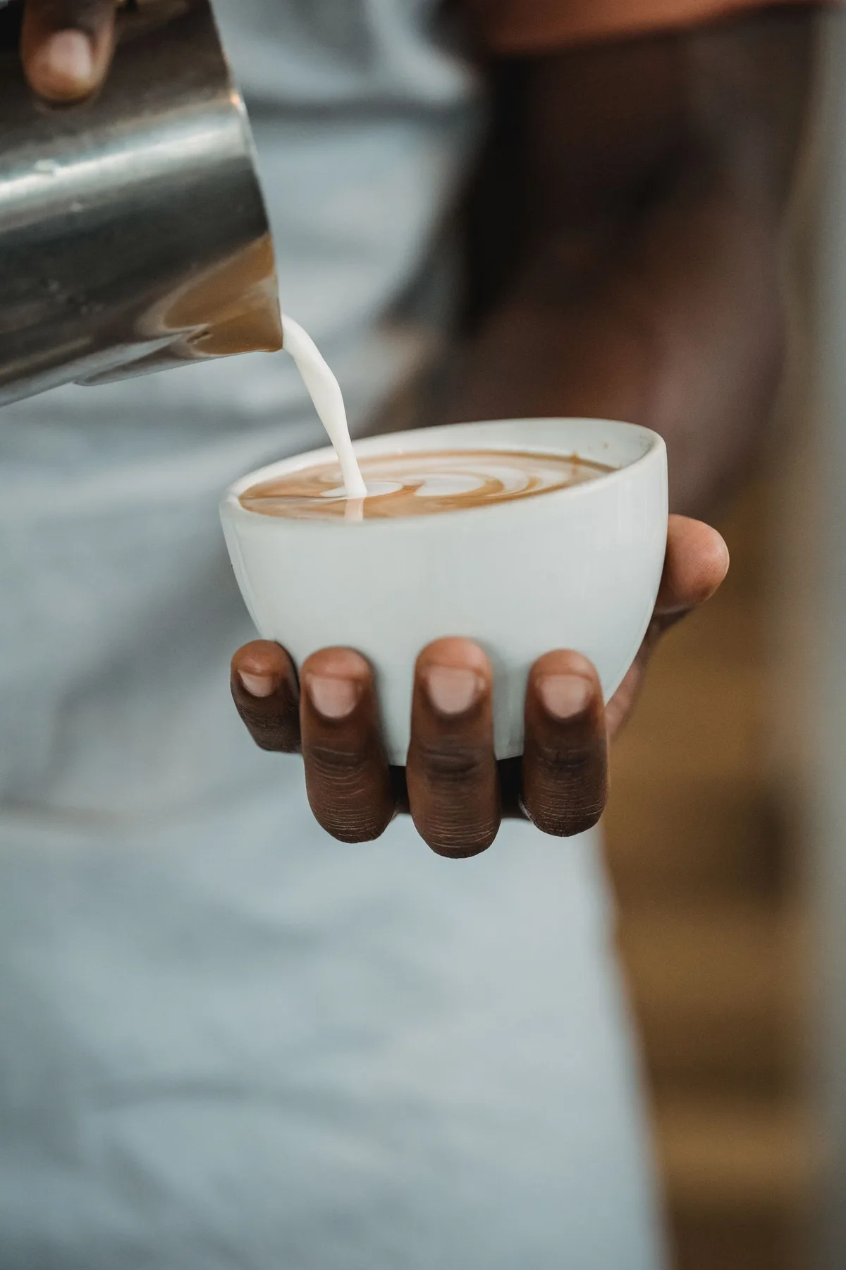 Barista crafting latte art at Cicada